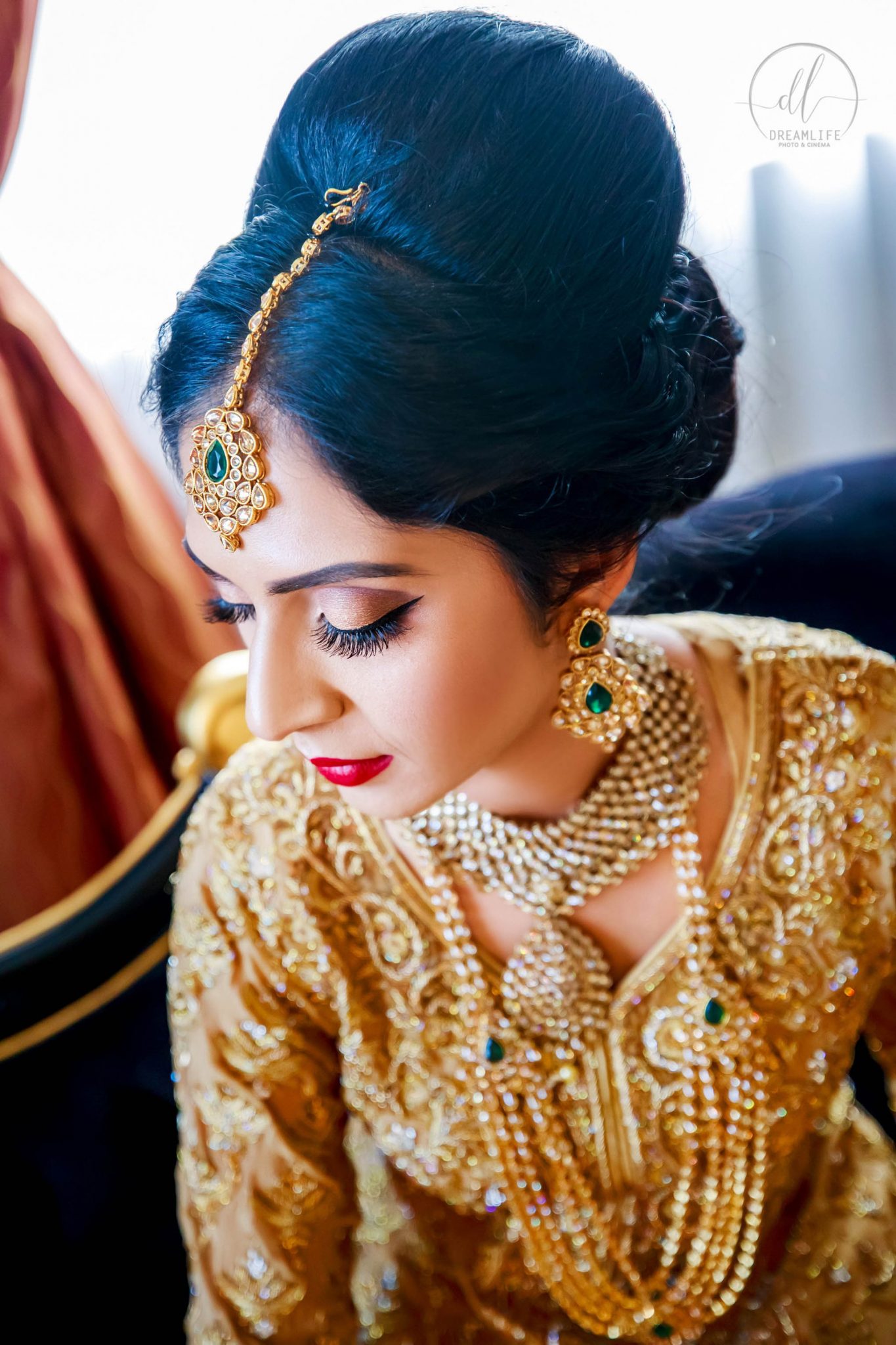 A pretty bride with her beautiful gold wedding outfit with gold accessories