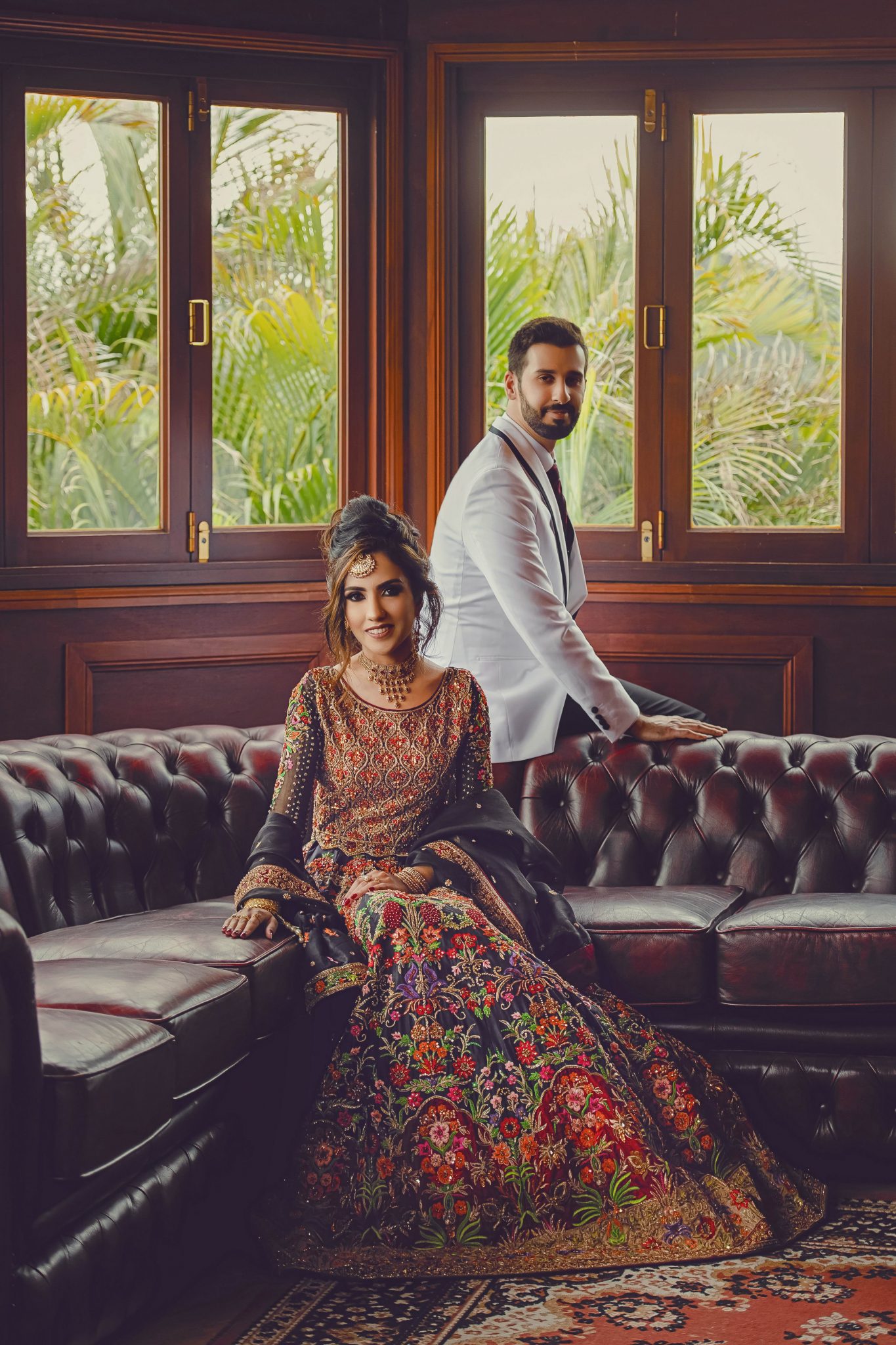 A Groom and Bride are sitting on a sofa