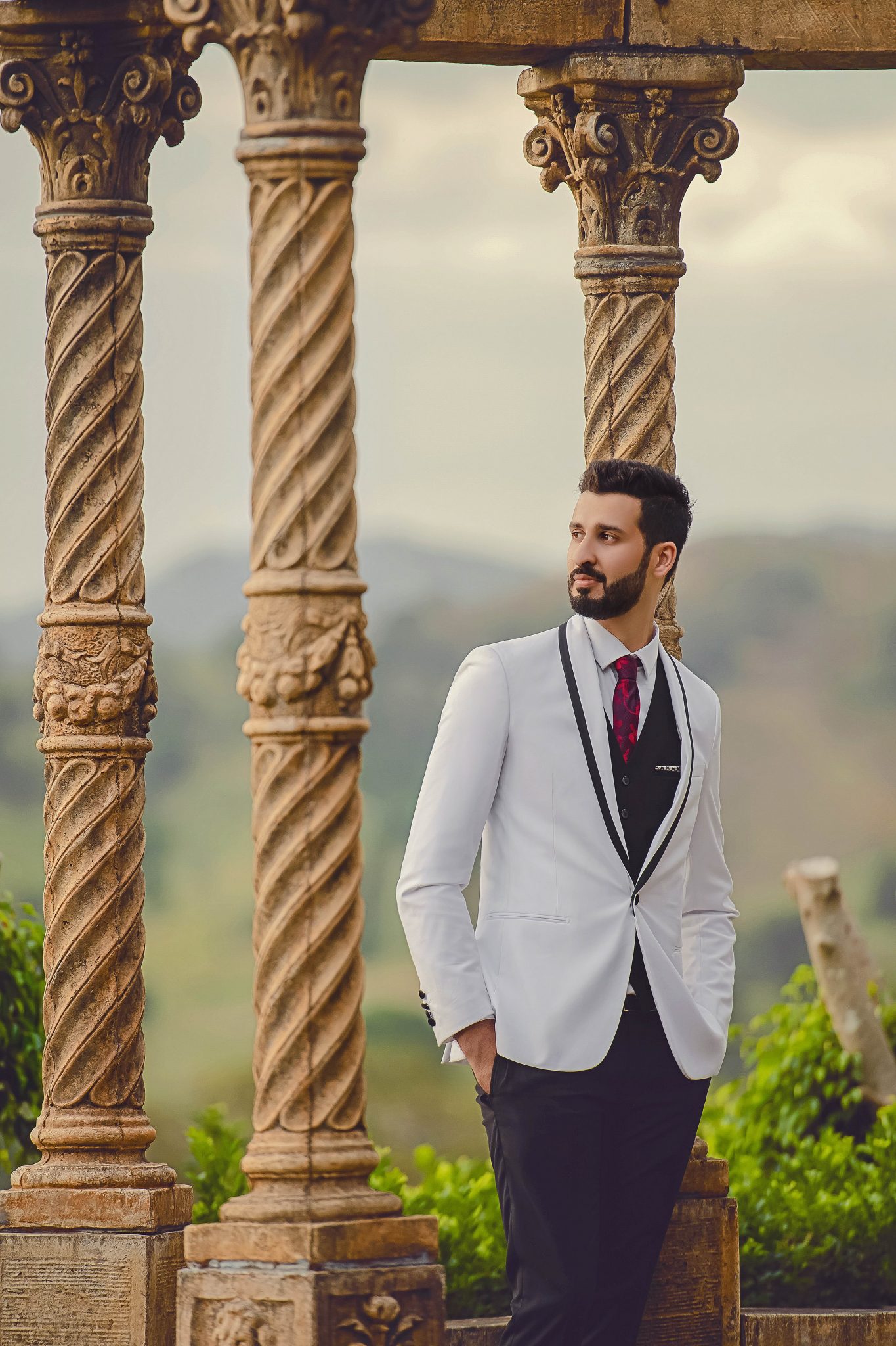 A groom standing and looking to his left side