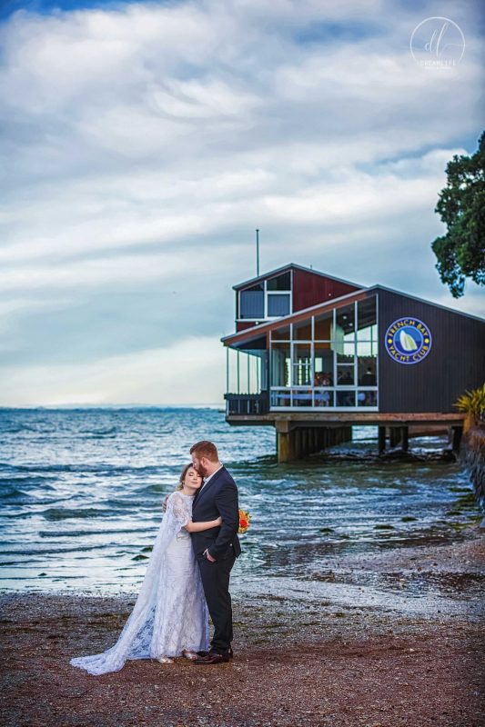 groom and bride in a restaurant and open sea backdrop