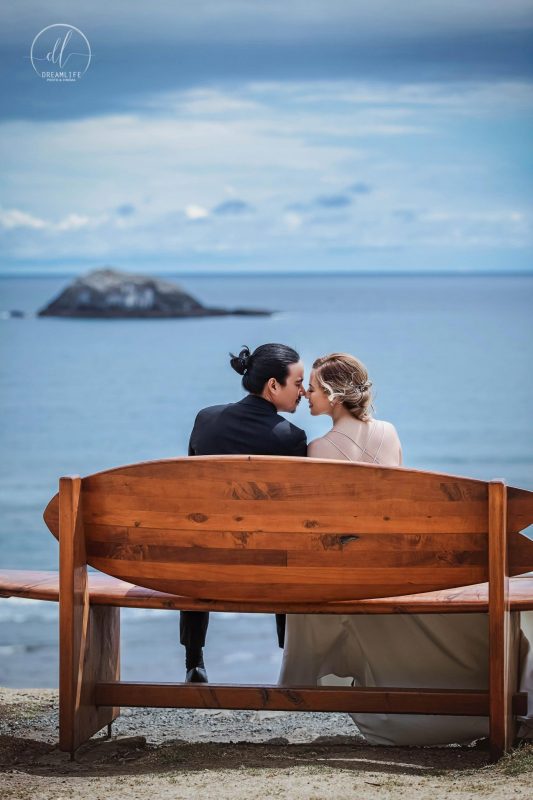 bride and groom kissing in an open sea backdrop