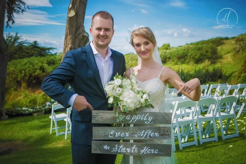 bride and groom holding a signage for their wedding