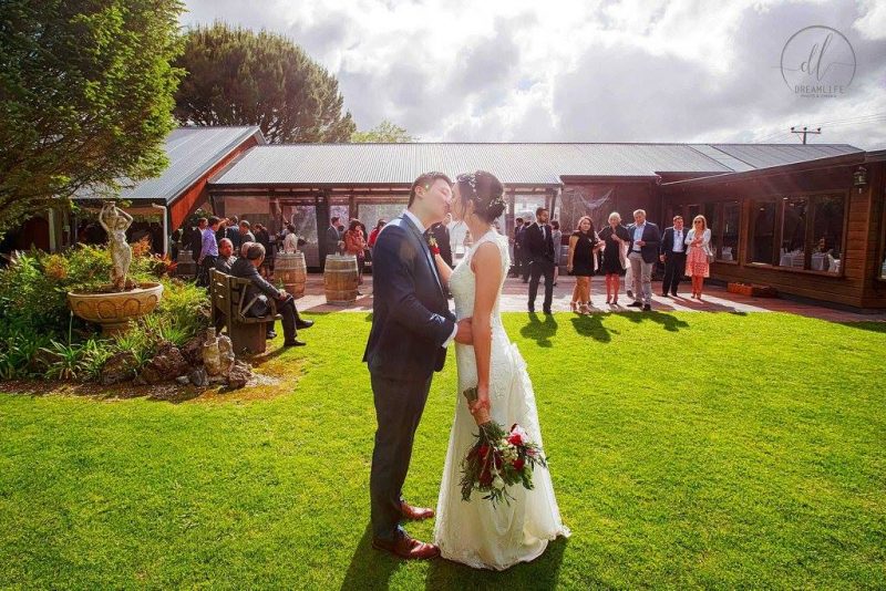 bride and groom kissing in a wedding venue