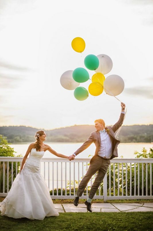 bride and groom holding a balloon