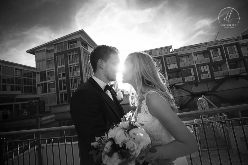 groom and bride in with a city building backdrop