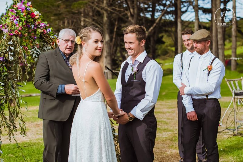 groom and wife in a wedding ceremony with a pastor and groomsmen