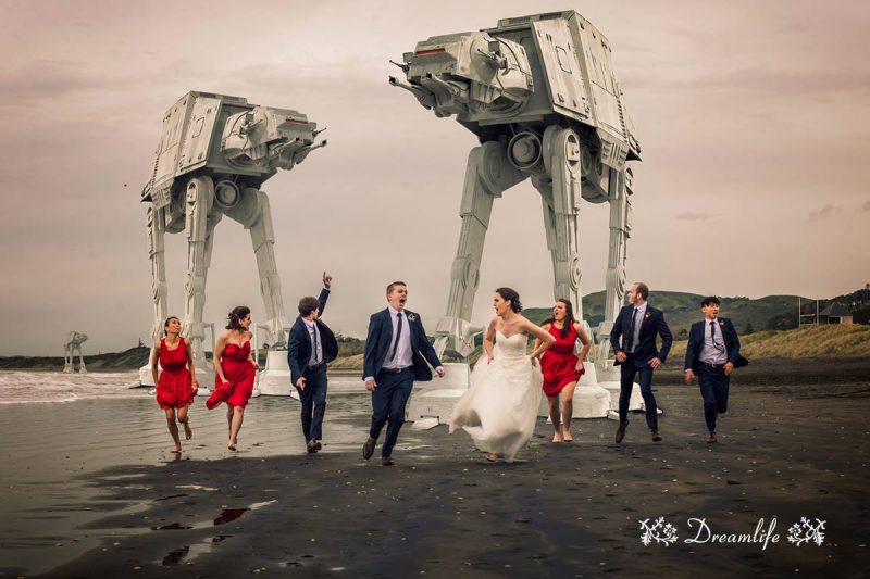 groom and bride running with their entourage with two robots