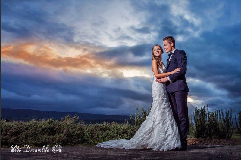 groom and bride in a scenic skyline backdrop