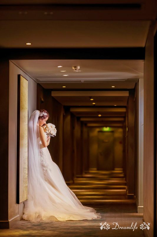 bride standing in a hotel corridor