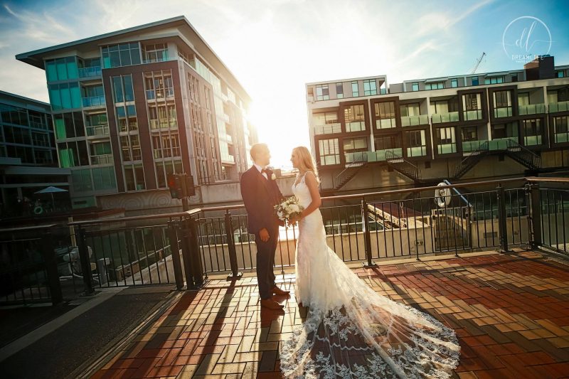 bride and groom in auckland city building and sunset backdrop