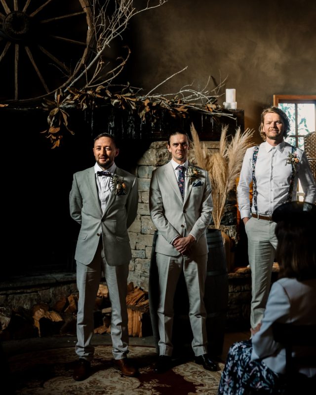 groom with his best man and groomsmen in a wedding altar